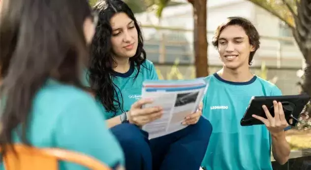 Estudantes do Colégio Bernoulli segurando seu material didático.